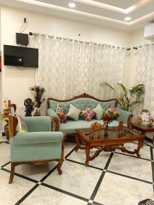 a living room with a couch and a coffee table at Gupta Vilas - A Boutique Homestay in Agra