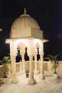 a gazebo with statues in front of it at Gupta Vilas - A Boutique Homestay in Agra