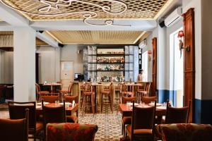 a restaurant with tables and chairs and a bar at SAYA La Villa in Mar Mikhael in Beirut +73 photos