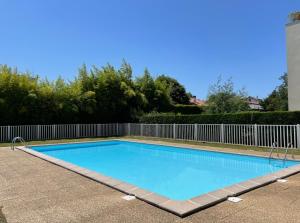 a swimming pool with a fence around it at Studio Bayonne avec Piscine in Bayonne