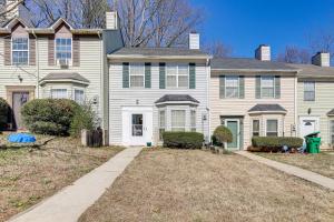 a large white house with a yard at Georgia Townhome - 3 Mi to Stone Mountain Park! in Stone Mountain