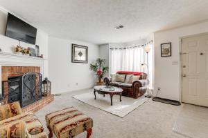 a living room with a couch and a fireplace at Georgia Townhome - 3 Mi to Stone Mountain Park! in Stone Mountain
