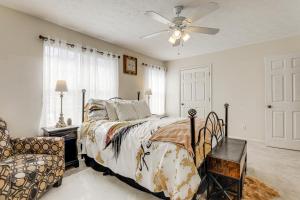 a bedroom with a bed and a ceiling fan at Georgia Townhome - 3 Mi to Stone Mountain Park! in Stone Mountain