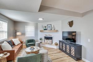 a living room with a couch and a fireplace at Modern and Stylish Olathe Home in Prime Location in Olathe
