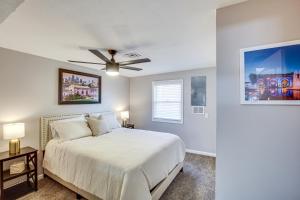 a bedroom with a bed and a ceiling fan at Modern and Stylish Olathe Home in Prime Location in Olathe