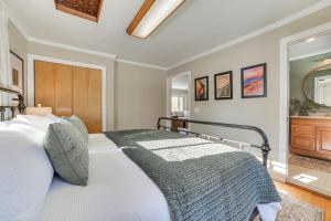 a bedroom with a bed and a large mirror at Riverfront Cheboygan Home with Deck and Boat Dock! in Cheboygan