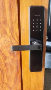 a black door handle on a wooden door at Earthy - Vintage in Shimoga