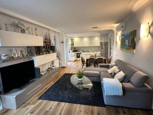 a living room with a couch and a television at Sergiunca in Bocca di Magra