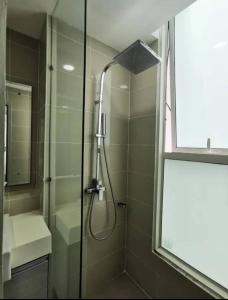 a shower with a glass door in a bathroom at Dreamland in Kota Kinabalu