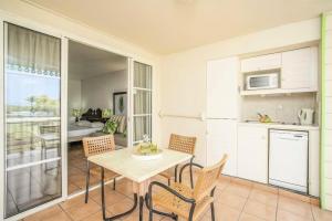 a kitchen and dining room with a table and chairs at Village Sainte Luce, Martinique - maeva Home - Studio 3 personnes - Prestige MAE-1304 in Sainte-Luce