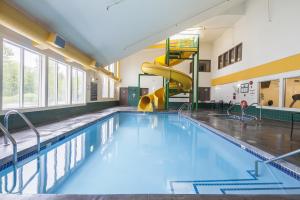 a swimming pool with a slide in a building at Mountain Retreat in Squamish