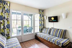 a living room with a couch and a window at Résidence Les Belles Rives - maeva Home - Appartement 2 pièces 5 personnes - Confort MAE-4404 in Argentat