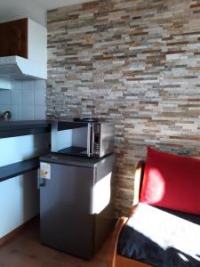 a kitchen with a microwave on top of a refrigerator at Résidence Hameau De Balestas Mp - 2 Pièces pour 6 Personnes 684 in Germ