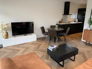 TV a/nebo společenská místnost v ubytování Luxe boshuisje Arlo in Ermelo!