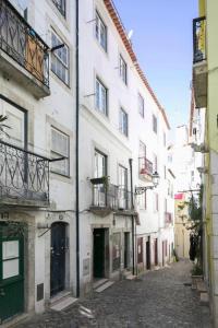 un callejón en una ciudad con un edificio blanco en gold 26 en Lisboa
