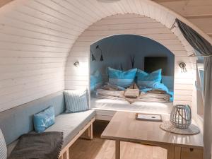 a bed in a room with a table and a bench at Tiny Igloo Elrond in Belau
