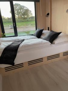 a large bed in a room with a large window at Nordic Thor in Belau