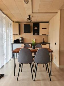 a kitchen with a wooden table and four chairs at Nordic Loki in Belau