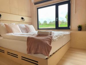 a bed in a room with a window at Nordic Loki in Belau