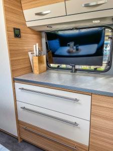 a tv sitting on top of a drawer in an rv at George Glamper FERNWEH in Belau