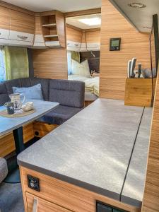 a kitchen and living room of an rv at George Glamper FERNWEH in Belau