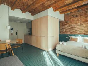 巴塞罗那Boutique Apartments 23 Barcelona的房间里有一张床和一张桌子的卧室