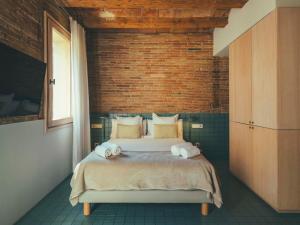 a bedroom with a bed with towels on it at Boutique Apartments 23 Barcelona in Barcelona