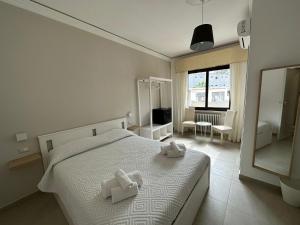 a bedroom with a bed with two white towels on it at MIRA taormina rooms in Taormina