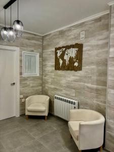 a bathroom with a tub and a chair and a radiator at Biznaga Nevada in Granada