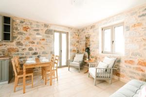a living room with a table and chairs at Villa Dioni Thio in Pírgos
