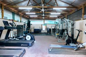 a gym with several treadmills and exercise machines at Acacia Village in Juba