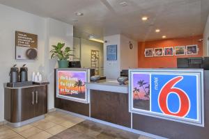a restaurant with a counter with a number six sign at Motel 6-Tulare, CA in Tulare