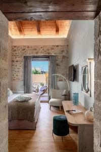 um quarto com uma cama e uma mesa num quarto em Mansio Boutique Hotel em Rethymno Town