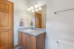 a bathroom with a sink and a mirror at Portland Park Townhome Unit 1 in Ouray +24 photos