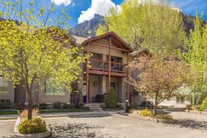 a house with a balcony and trees in front at Portland Park Townhome Unit 1 in Ouray