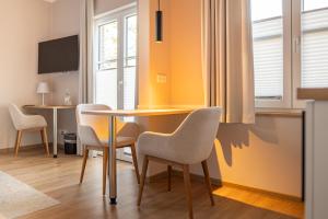 a dining room with a table and chairs at Hotel Seeblick in Thülsfeld