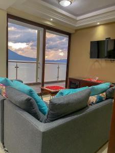 a living room with a couch with pillows on it at Torres de Atitlan 14 nivel in Panajachel