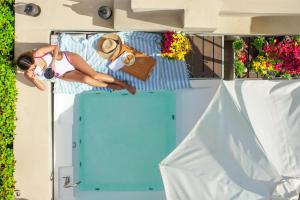 a woman laying on a bed in a tiny house at Mansio Boutique Hotel in Rethymno Town