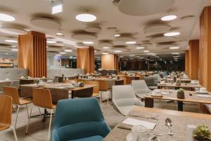 a dining room with tables and chairs and tablesktop at Don Gregory by Dunas - Adults Only in San Agustin