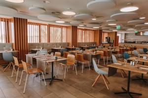 a restaurant with tables and chairs in a room at Don Gregory by Dunas - Adults Only in San Agustin