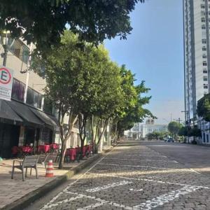 a cobblestone street with trees on the side of the road at Hotel Manaós in Manaus