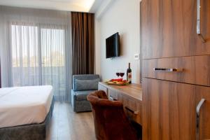 a hotel room with a bed and a desk and a chair at ÇINAR BUTİK OTEL in Bodrum City