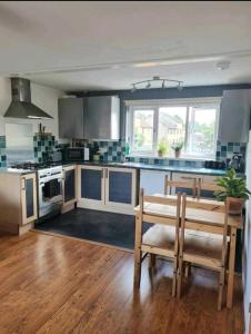 a kitchen with a bench and a table in it at Stunning 2-Bed House in Weston-super-Mare in Weston-super-Mare