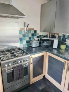 a kitchen with a stove and a microwave at Stunning 2-Bed House in Weston-super-Mare in Weston-super-Mare