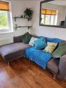 a blue couch in a living room with a mirror at Stunning 2-Bed House in Weston-super-Mare in Weston-super-Mare