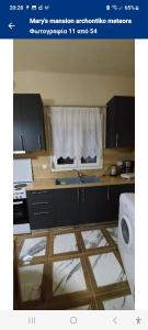 a picture of a kitchen with a window in it at Meteora Mary's mansion in Kalabaka