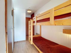 a room with two bunk beds and a hallway at La Résidence RS0224 Bat.2 in La Clusaz