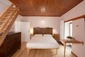 a bedroom with a bed and a wooden ceiling at Casa Gemma in Rimella