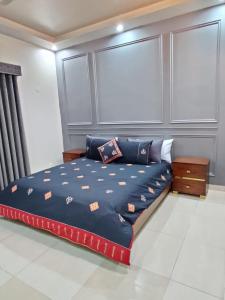 a bedroom with a bed with blue sheets on it at Supreme Villa Block 6 Gulshan-e-iqbal Auto Generator in Karachi