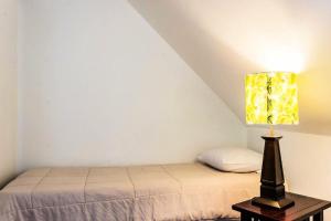 a bedroom with a bed and a lamp on a table at Village Sainte Luce, Martinique - maeva Home - Appartement 3 pièces 6 personnes - Prestige MAE-8354 in Sainte-Luce +8 photos